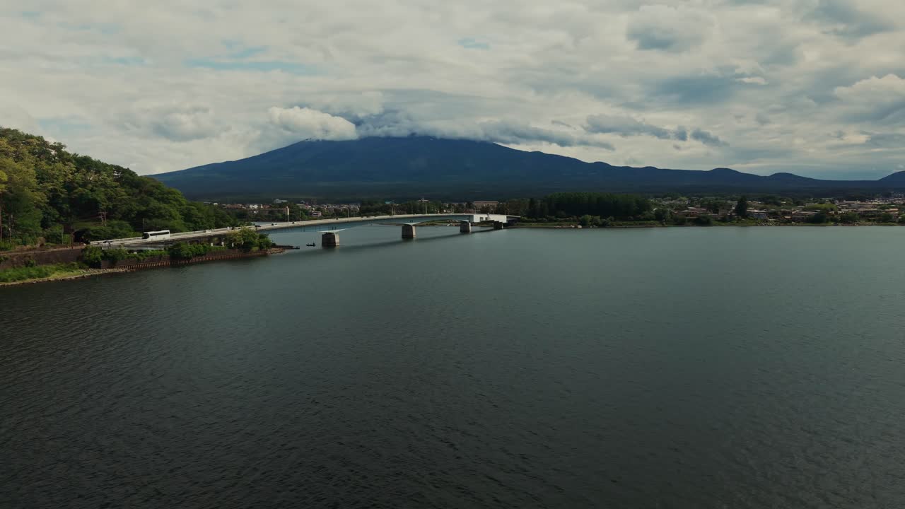 Mount Fuji over a lake with a bridge