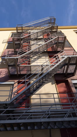 clouds passing over a cool industrial building, with exterior metal staircase in vertical