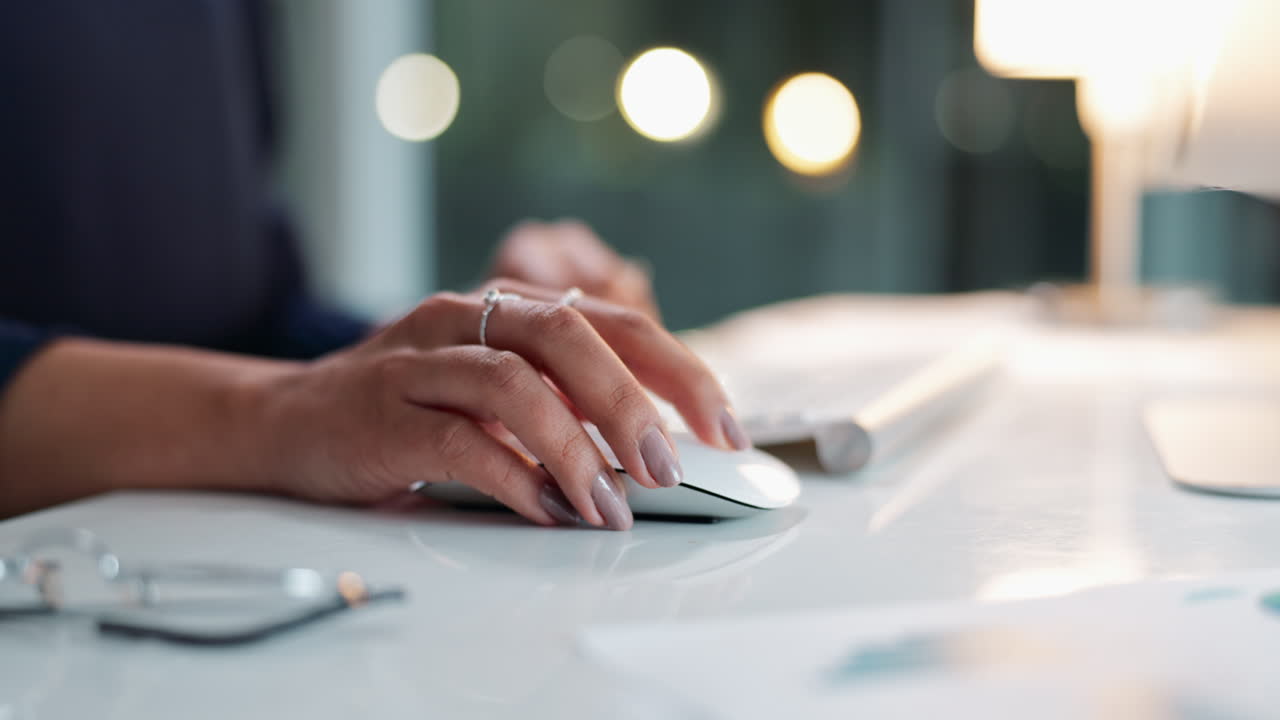 Close-up of hand using computer mouse on desk