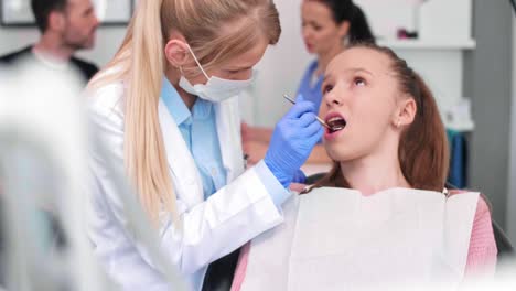 Blurred-view-of-dentist-using-dental-mirror-during-checkup