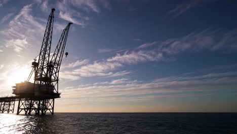 offshore oil rig silhouette at sunset