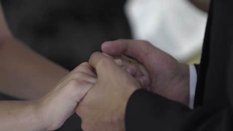 Bride-and-groom-exchanging-vows-in-front-of-priest