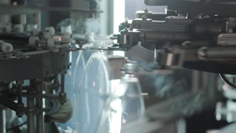 automatic filling machine pours water into plastic pet bottles at modern beverage plant