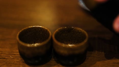 sake being poured into two cups