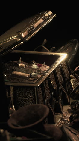 close up of an ornate treasure chest filled with gold, jewels, and coins