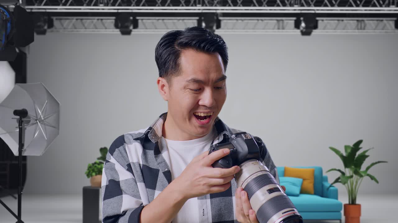 Photographer checking camera in studio