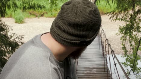 man on a wooden bridge in a forest