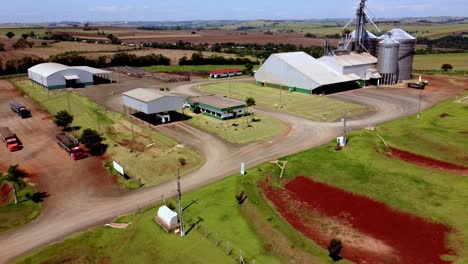 Pullback-Drone-View-Farm-Establishment-Grain-Silos-Barn-Farm-Land