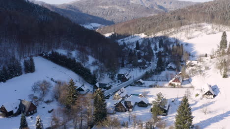 picturesque czech village in a winter mountain valley,cottages in snow