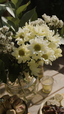 floral arrangement and snacks on a wooden table