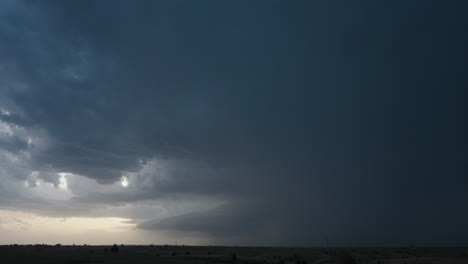 dramatic storm clouds with lightning over rural landscape at dusk
