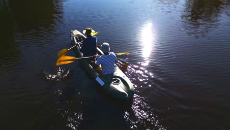 lake, camp and men in kayak in nature from above