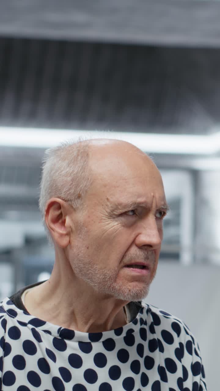 Vertical Video Doctor in hazmat suit administers medical care to a contagious patient