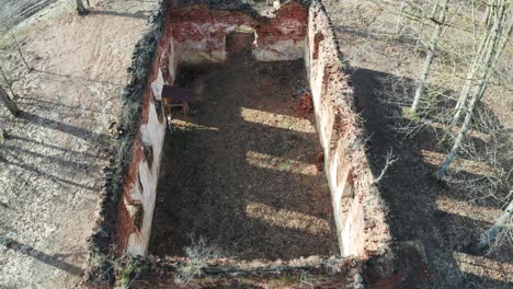 Flying-above-abandoned-and-destroyed-church-brick-wall-outline-remains