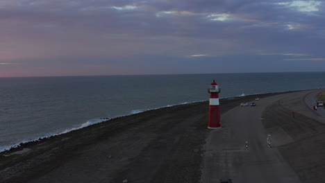 El-Faro-De-Westkapelle-Durante-Una-Puesta-De-Sol-Naranja-Brillante,-Con-Mucho-Viento