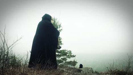 wizard casting a spell on a cliff side overlook