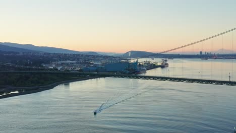 Stunning-Drone-Shot-at-Lions-Gate-Bridge,-Vancouver-showing-land-and-marine-traffic