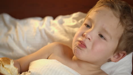 Cute-kid-with-a-bun-in-bed