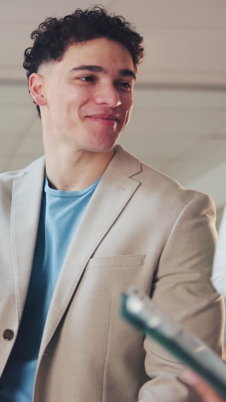 Young Man Smiling and Giving High Five in Office