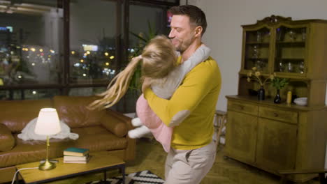 father and daughter playing in the living room at home