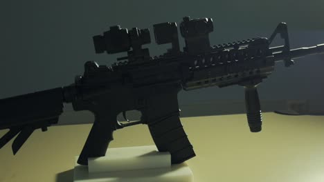 all black army assault rifle with a scope attached to it