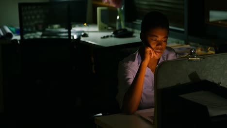 female executive working on laptop at desk 4k