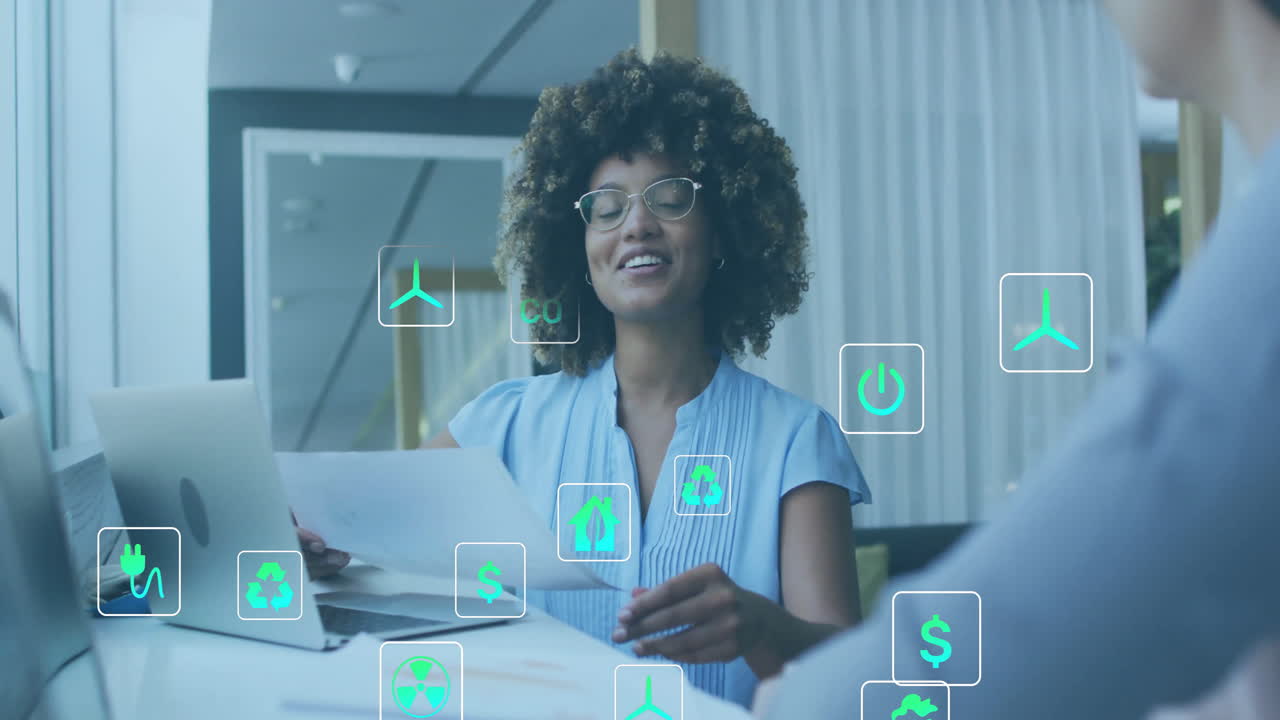 Animation of ecology icons over diverse colleagues discussing work in office