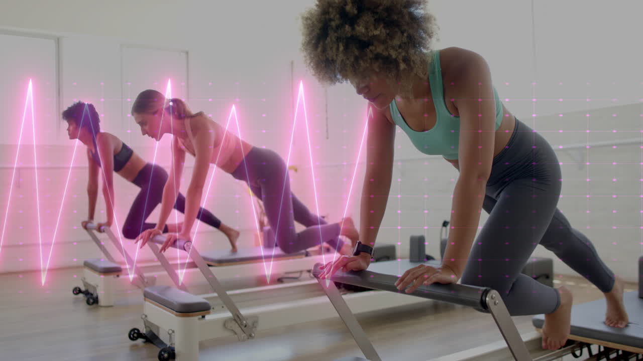 Women exercising on reformer machines with pink heartbeat animation overlay