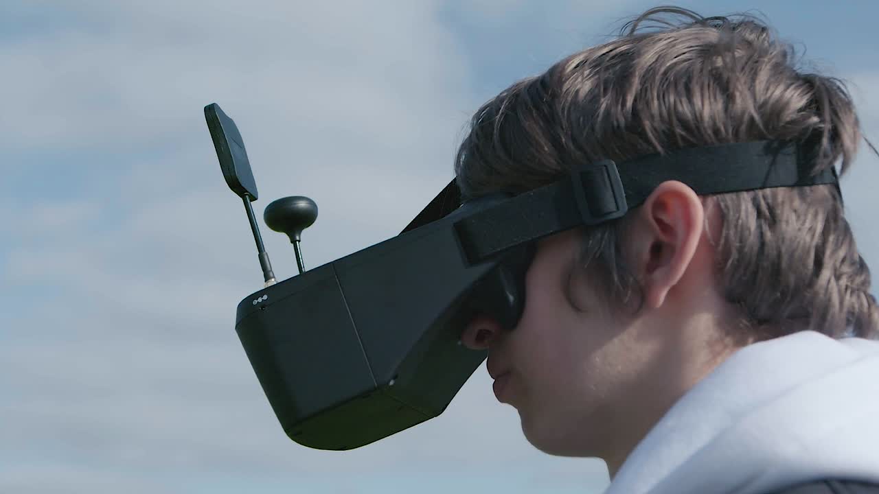 Teenage boy flying FPV acrobatic drone