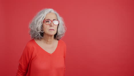 older woman adjusting glasses