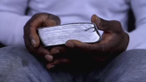 man-praying-to-god-with-hands-together-with-bible-Caribbean-man-praying-with-white-background-stock-footage