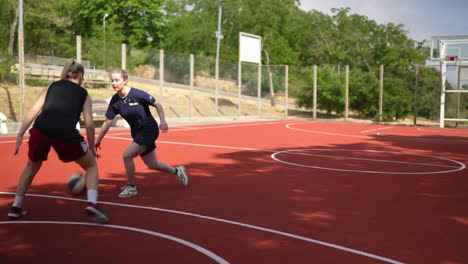 women playing basketball outdoors