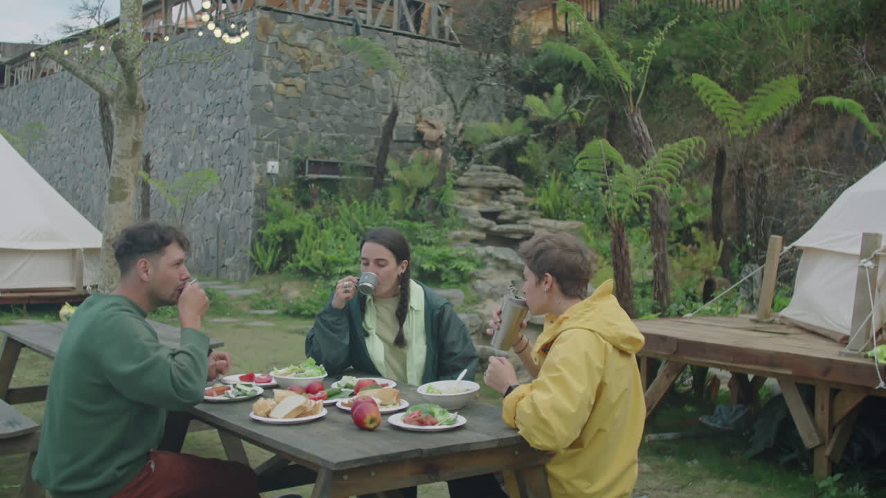 Tourists Enjoying Dinner Outdoors at Glampsite