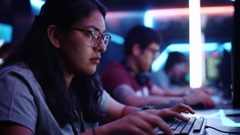 a focused gamer engaged in esports action at a darkly lit gaming arena, showcasing intense concentration and skill on the keyboard