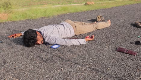 concept of road accident of crime scene, pan view of young adult man dead body on the road