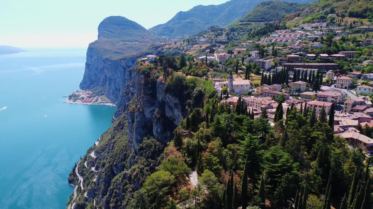 Sheer cliffs plunge into Lake Garda’s vibrant blue waters, with winding roads and terraced villages clinging to the slopes.