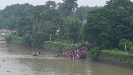 gathering of people and tarpan at dakshineswar temple in kolkata on mahalaya day on the eve of durga puja.