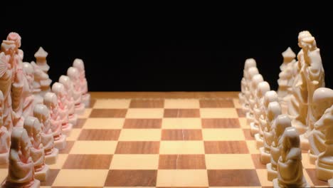 chessboard concept, pieces in formation, person hand move one pawn forward