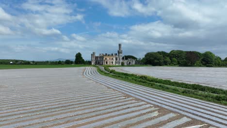 ireland epic locations aerial drone flying slowly over crops and road at ducketts castle tullow carlow ireland