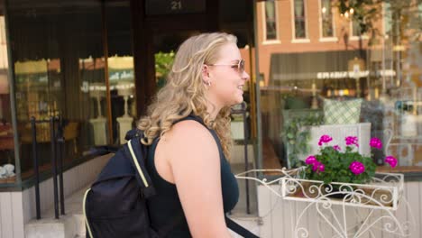 profile of girl as she smiles and walks through the city
