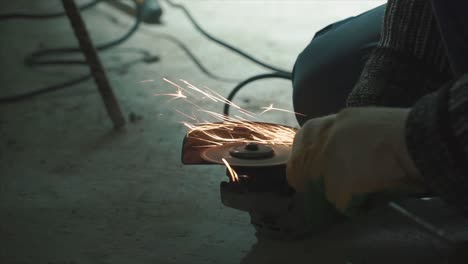 worker grinding metal on construction site