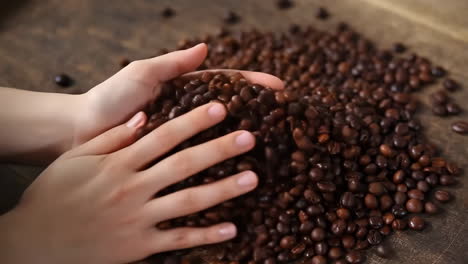hands sifting through coffee beans