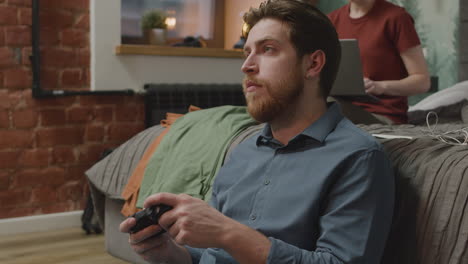 boy playing video games sitting on the floor in bedroom