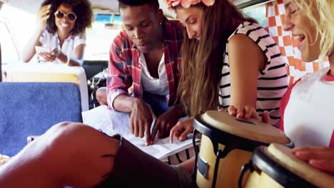 friends looking at map in van 4k