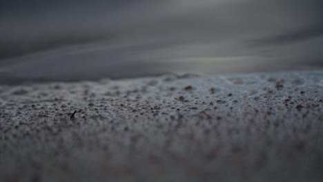 close-up shot of soft waves hitting shore on the lake, view of tranquility