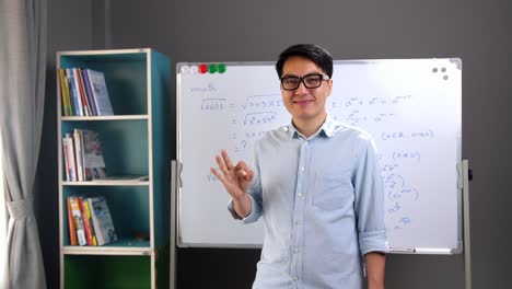 asian teacher showing ok sign