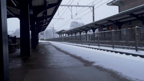 long static shot of snow falling at a vacant train station in new jersey