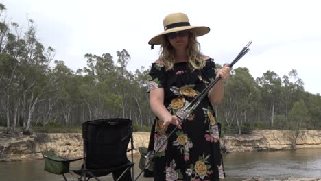 Outdoor-nature-blonde-woman-packing-up-tent-poles-camping-australian