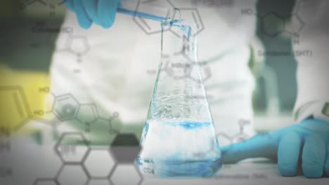 vaso de laboratorio y tubo de ensayo con datos y fórmula estructural de los compuestos químicos en el foregr