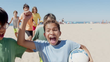 long shot of teenagers running on beach and rejoicing winning